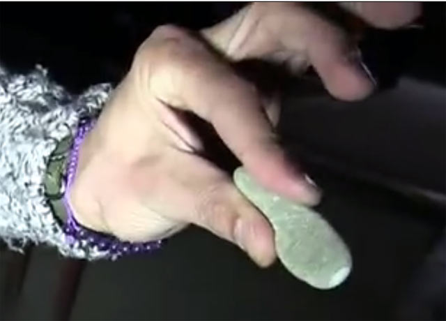 From the YouTube video: the stone tool shaped to be held between fingers, with an oval cut quartz stone inlay at the tip.
